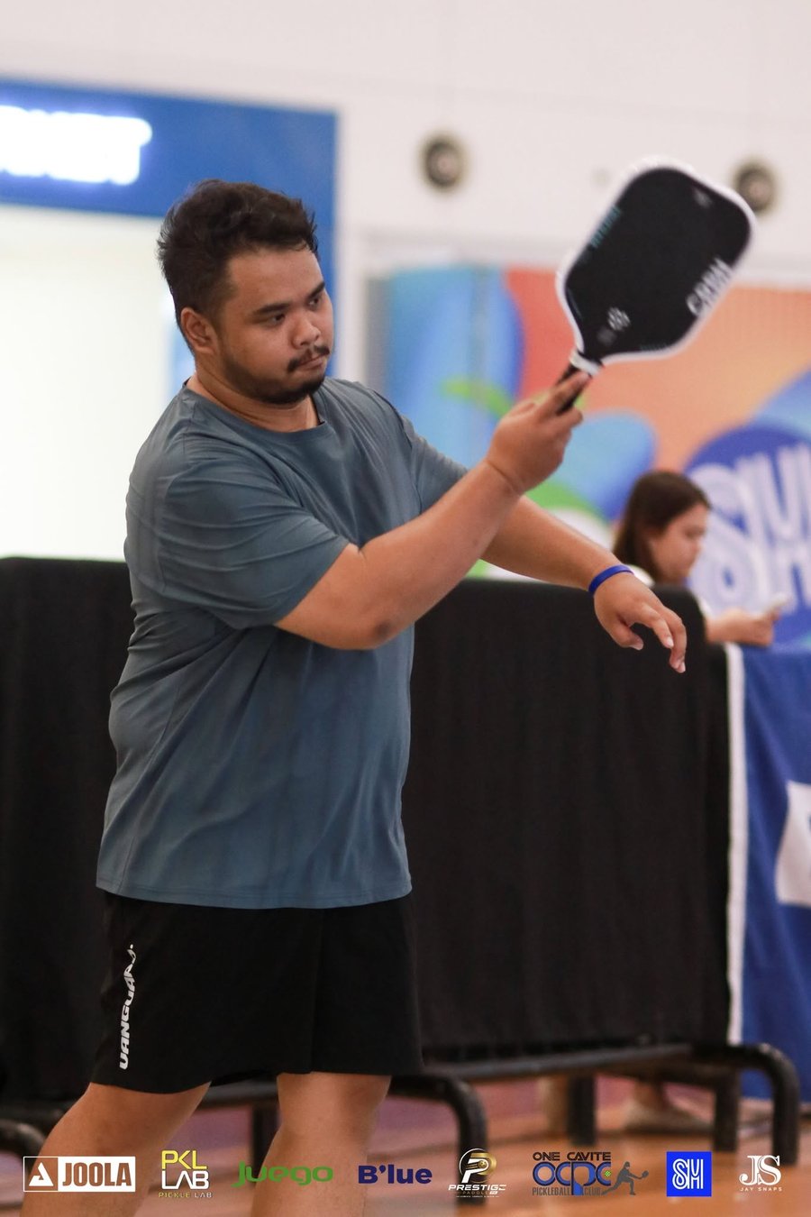 Uzz playing pickleball